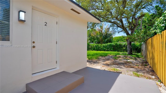 2820 NW 95th St, Miami, FL 33147 - doorway to property featuring a patio area and stucco siding