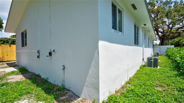 2820 NW 95th St, Miami, FL 33147 - view of side of property with stucco siding and a central AC unit