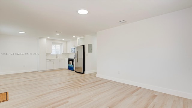2820 NW 95th St, Miami, FL 33147 - unfurnished living room featuring light wood-style flooring and recessed lighting