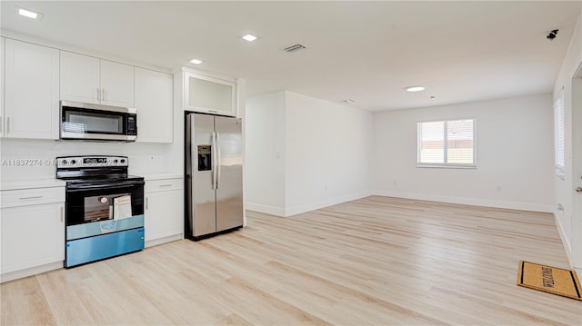2820 NW 95th St, Miami, FL 33147 - kitchen with stainless steel appliances, light wood-type flooring, light countertops, white cabinets, and recessed lighting