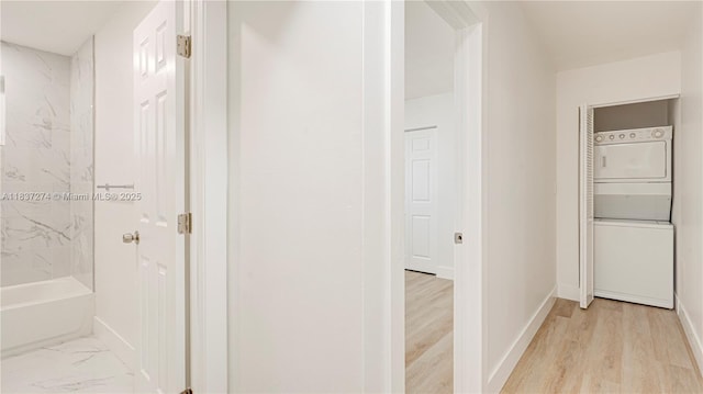 2820 NW 95th St, Miami, FL 33147 - corridor with stacked washer / dryer and light wood-type flooring