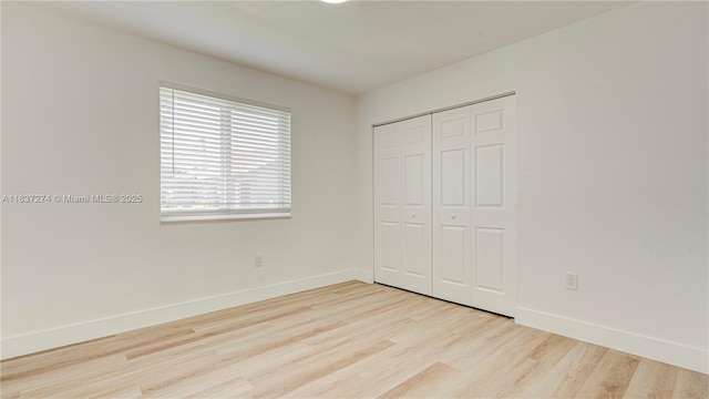 2820 NW 95th St, Miami, FL 33147 - unfurnished bedroom with wood finished floors and a closet