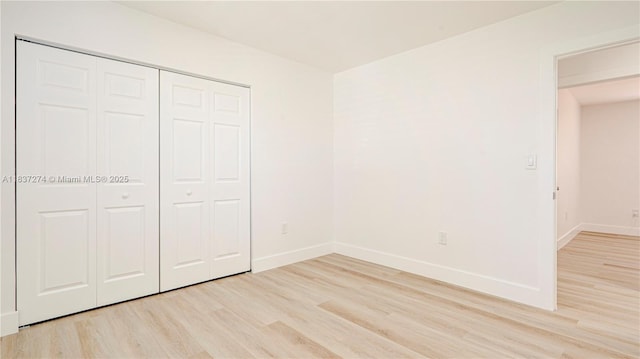 2820 NW 95th St, Miami, FL 33147 - unfurnished bedroom featuring light wood-style flooring and a closet