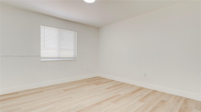 2820 NW 95th St, Miami, FL 33147 - spare room featuring wood finished floors and baseboards