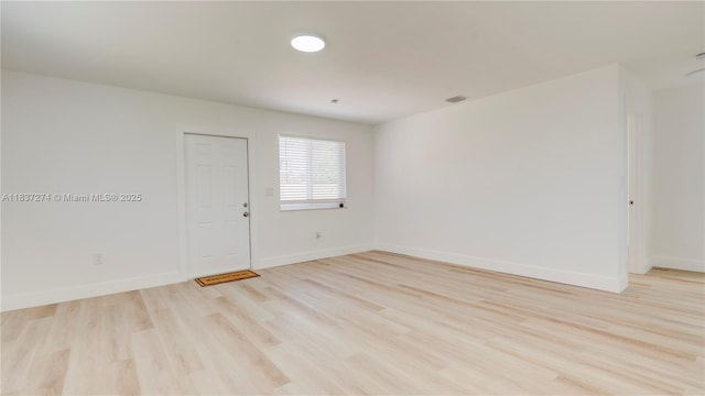2820 NW 95th St, Miami, FL 33147 - spare room featuring light wood-style floors and baseboards