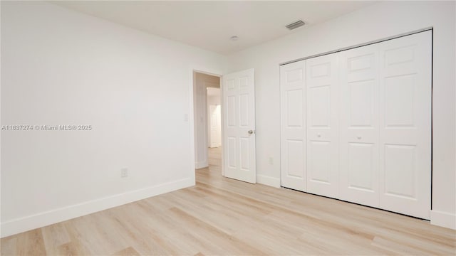 2820 NW 95th St, Miami, FL 33147 - unfurnished bedroom featuring light wood-style floors and a closet