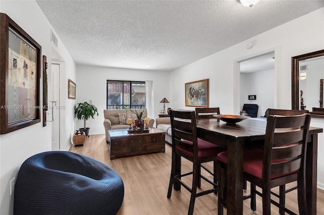9730 Hammocks Blvd Unit 201-28, Miami, FL 33196 - dining space with light wood-style floors and a textured ceiling