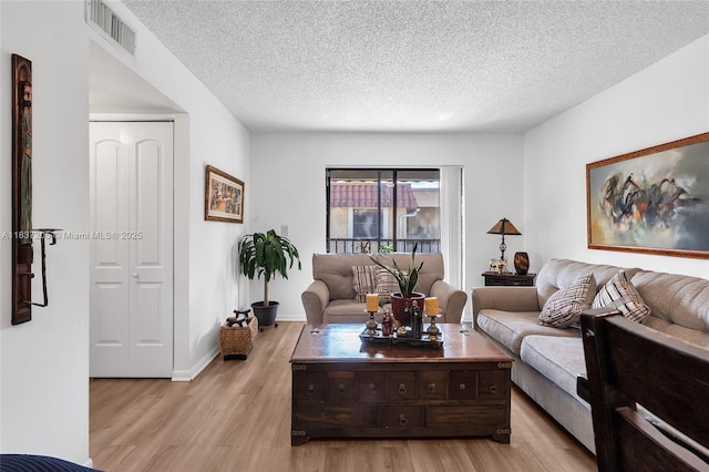 9730 Hammocks Blvd Unit 201-28, Miami, FL 33196 - living room featuring light wood-type flooring and a textured ceiling