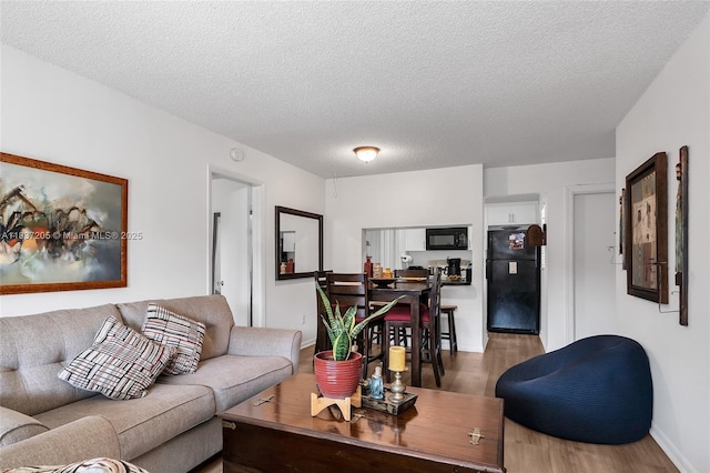 9730 Hammocks Blvd Unit 201-28, Miami, FL 33196 - living room featuring wood finished floors and a textured ceiling