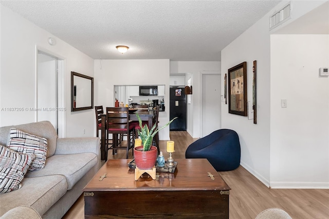 9730 Hammocks Blvd Unit 201-28, Miami, FL 33196 - living area with light wood finished floors and a textured ceiling