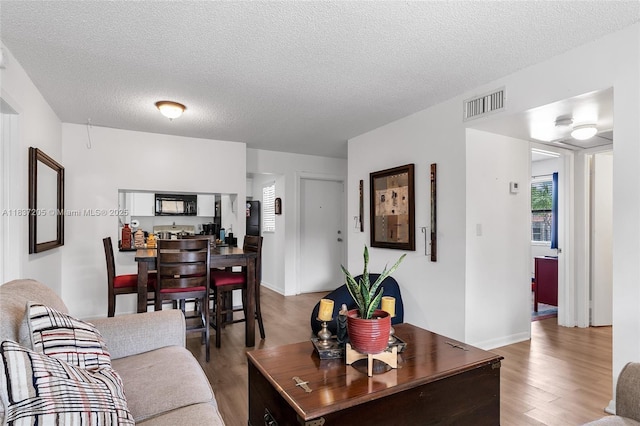 9730 Hammocks Blvd Unit 201-28, Miami, FL 33196 - living area featuring wood finished floors and a textured ceiling