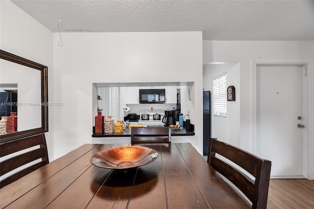 9730 Hammocks Blvd Unit 201-28, Miami, FL 33196 - dining area featuring wood finished floors and a textured ceiling