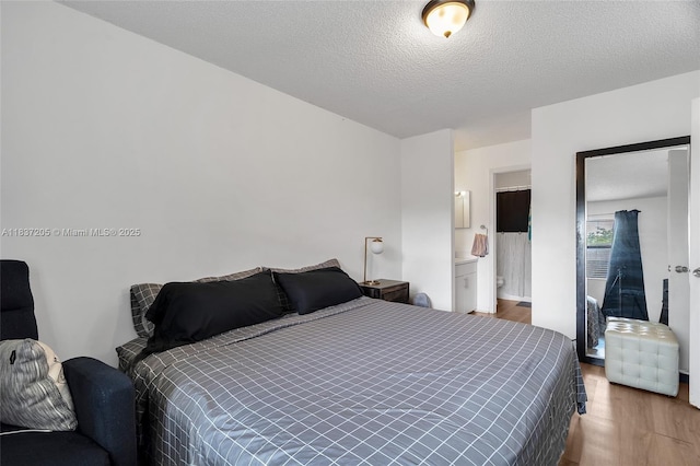 9730 Hammocks Blvd Unit 201-28, Miami, FL 33196 - bedroom with wood finished floors and a textured ceiling