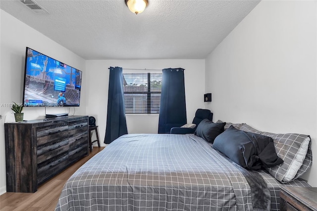9730 Hammocks Blvd Unit 201-28, Miami, FL 33196 - bedroom with wood finished floors and a textured ceiling