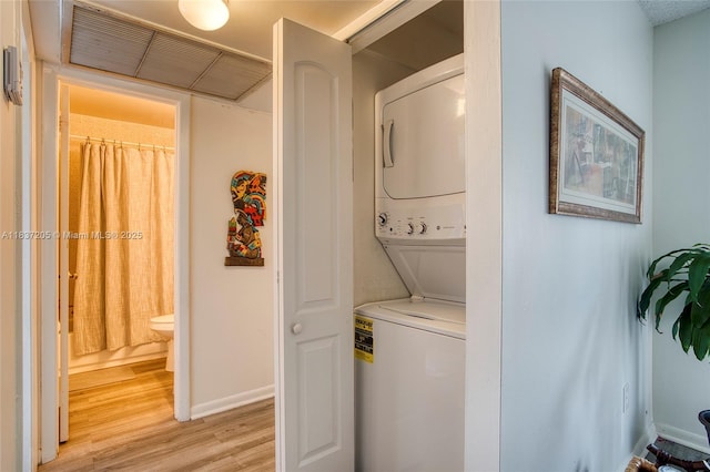 9730 Hammocks Blvd Unit 201-28, Miami, FL 33196 - laundry area featuring estacked washer and dryer and light wood-style flooring