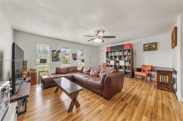 521 NE Dinner, Dinner, Palm Bay, FL 32907 - living room with a ceiling fan, light wood-style flooring, and a textured ceiling
