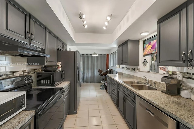 521 NE Dinner, Dinner, Palm Bay, FL 32907 - kitchen featuring black appliances, under cabinet range hood, light tile patterned floors, decorative backsplash, and a raised ceiling