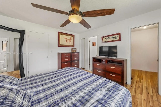 521 NE Dinner, Dinner, Palm Bay, FL 32907 - bedroom with light wood-style flooring, a ceiling fan, and ensuite bath