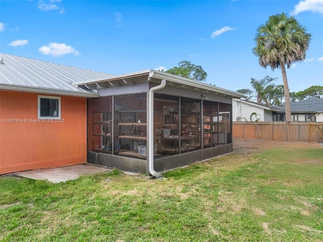 521 NE Dinner, Dinner, Palm Bay, FL 32907 - rear view of property with a sunroom and a metal roof