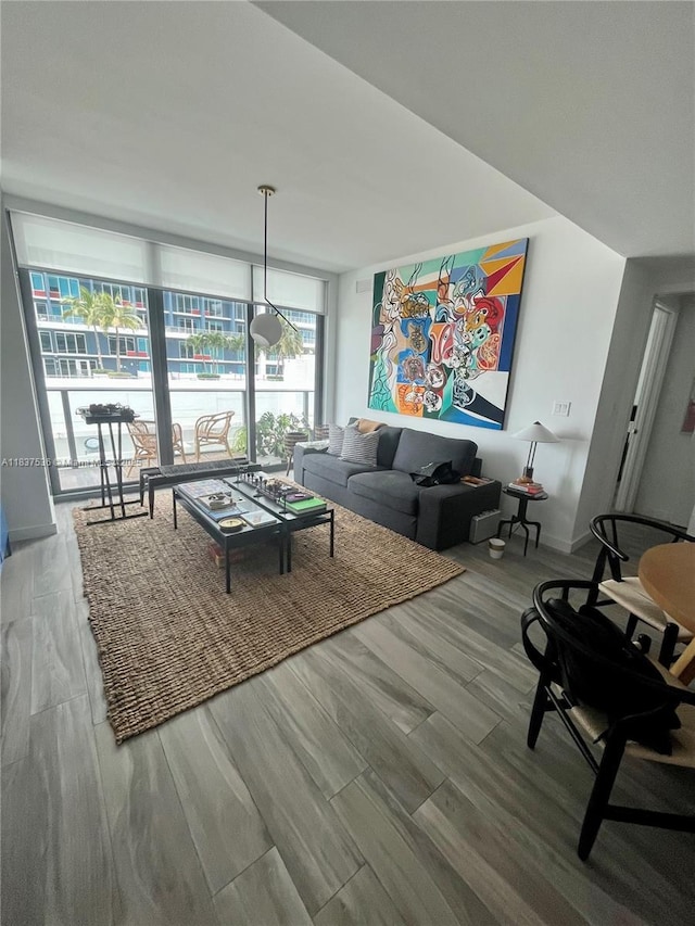 1300 S Miami Ave Unit 1207, Miami, FL 33130 - living area featuring plenty of natural light, wood finished floors, and a wall of windows