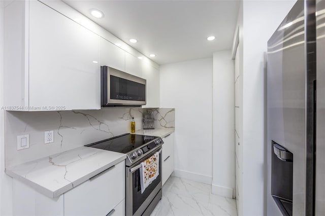 701 Brickell Key Blvd Unit 2011, Miami, FL 33131 - kitchen with appliances with stainless steel finishes, light marble finish flooring, modern cabinets, recessed lighting, and white cabinetry
