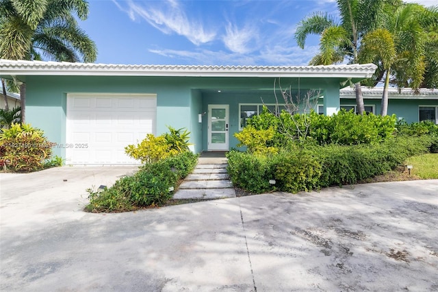 121 SE 7th St, Pompano Beach, FL 33060 - view of front of home with a garage, stucco siding, and concrete driveway