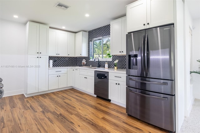 121 SE 7th St, Pompano Beach, FL 33060 - kitchen with stainless steel fridge with ice dispenser, dishwashing machine, tasteful backsplash, white cabinetry, and light countertops