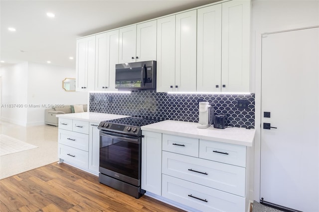 121 SE 7th St, Pompano Beach, FL 33060 - kitchen with appliances with stainless steel finishes, decorative backsplash, white cabinets, light countertops, and recessed lighting