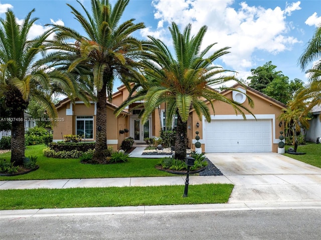 3043 Lakewood Dr, Weston, FL 33332 - view of property hidden behind natural elements featuring stucco siding, driveway, a garage, and a front yard
