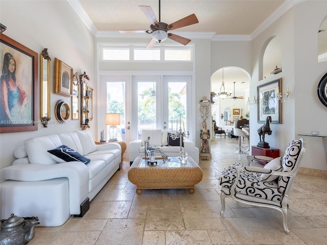 3043 Lakewood Dr, Weston, FL 33332 - living room with stone tile floors, crown molding, a ceiling fan, arched walkways, and a high ceiling
