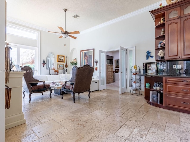 3043 Lakewood Dr, Weston, FL 33332 - living area featuring crown molding, stone tile flooring, ceiling fan, a towering ceiling, and a textured ceiling