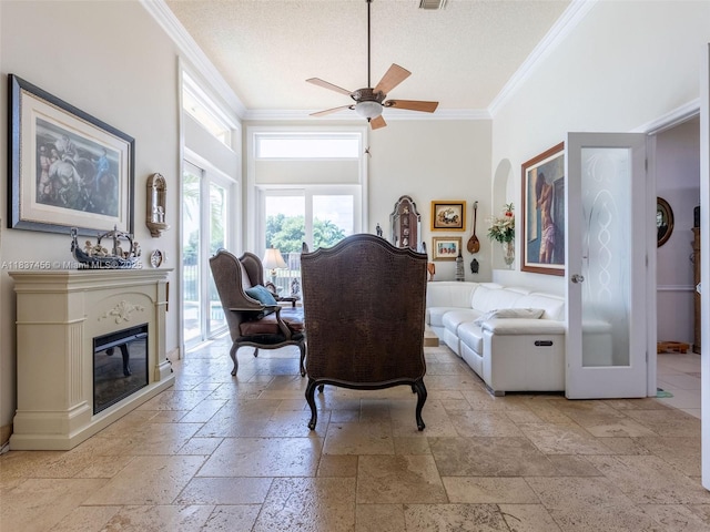 3043 Lakewood Dr, Weston, FL 33332 - dining space featuring crown molding, stone tile floors, a ceiling fan, a glass covered fireplace, and a textured ceiling