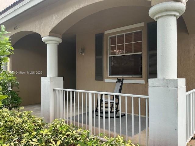 4603 Highgate Dr Unit C, Delray Beach, FL 33445 - entrance to property featuring a porch and stucco siding