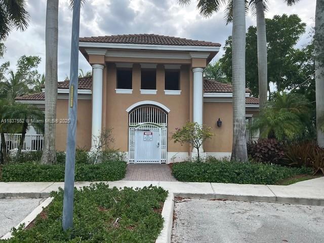 4603 Highgate Dr Unit C, Delray Beach, FL 33445 - view of front of home featuring a tile roof and stucco siding