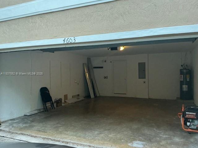 4603 Highgate Dr Unit C, Delray Beach, FL 33445 - garage featuring water heater and electric panel