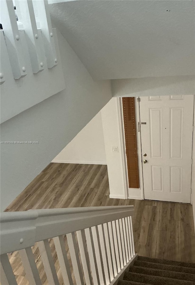 4603 Highgate Dr Unit C, Delray Beach, FL 33445 - stairs featuring wood finished floors, vaulted ceiling, and electric panel