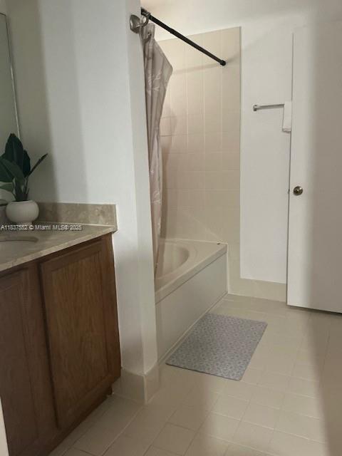 4603 Highgate Dr Unit C, Delray Beach, FL 33445 - full bath featuring shower / bath combo with shower curtain, vanity, and tile patterned floors