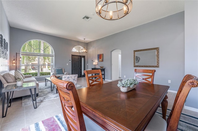 1122 NW 143rd Ave, Pembroke Pines, FL 33028 - dining area with a chandelier, arched walkways, and light tile patterned floors