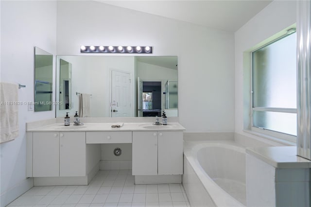 1122 NW 143rd Ave, Pembroke Pines, FL 33028 - bathroom with healthy amount of natural light, a garden tub, double vanity, and tile patterned flooring