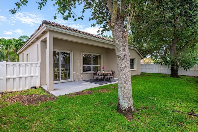 1122 NW 143rd Ave, Pembroke Pines, FL 33028 - back of property featuring a fenced backyard, stucco siding, a patio area, and a tile roof