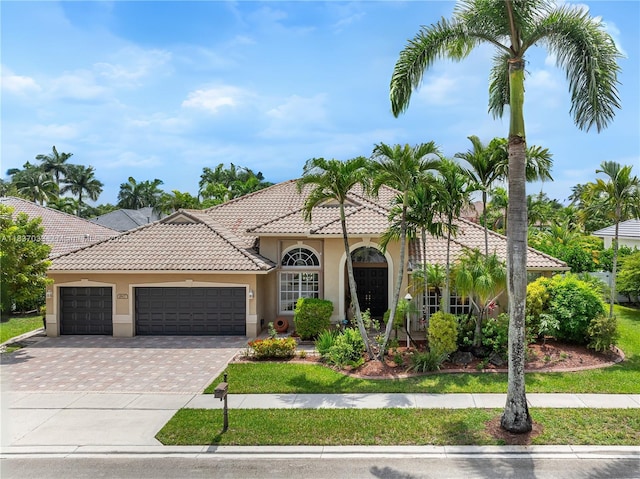 1907 NW 137th Ter, Pembroke Pines, FL 33028 - mediterranean / spanish house featuring stucco siding, a tile roof, an attached garage, and driveway