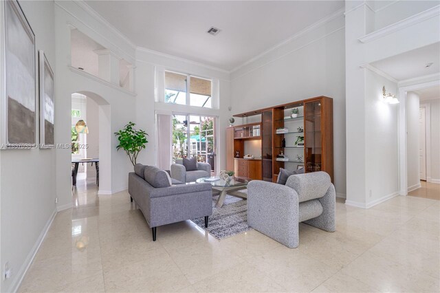1907 NW 137th Ter, Pembroke Pines, FL 33028 - living area featuring arched walkways, a towering ceiling, and crown molding