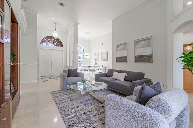1907 NW 137th Ter, Pembroke Pines, FL 33028 - tiled living room with crown molding, arched walkways, and a chandelier