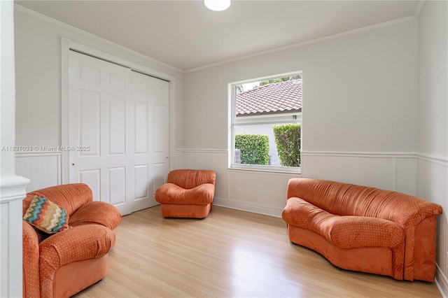 1907 NW 137th Ter, Pembroke Pines, FL 33028 - living area with crown molding, light wood-type flooring, and a wainscoted wall