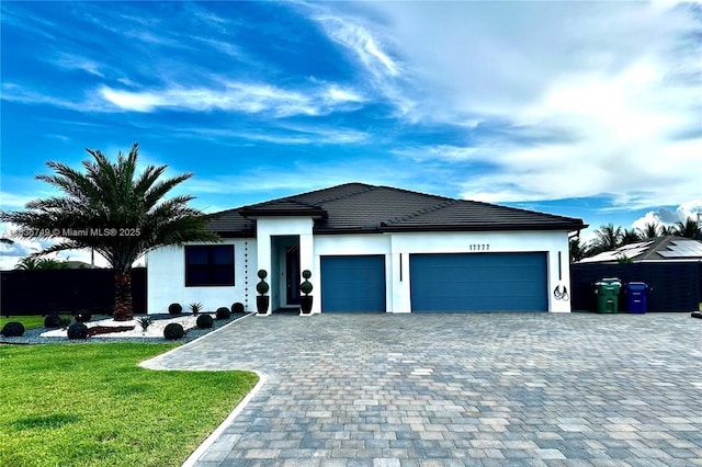 17777 SW 295th St, Homestead, FL 33030 - view of front of property featuring an attached garage, decorative driveway, a front lawn, and stucco siding