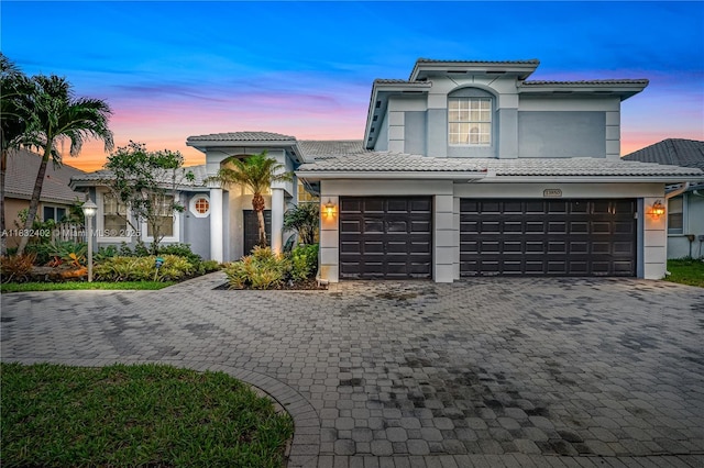 13850 NW 23rd St, Pembroke Pines, FL 33028 - mediterranean / spanish house featuring stucco siding, a tile roof, a garage, and decorative driveway