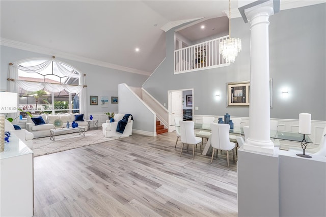 13850 NW 23rd St, Pembroke Pines, FL 33028 - living room featuring ornate columns, a towering ceiling, ornamental molding, stairs, and wood finished floors