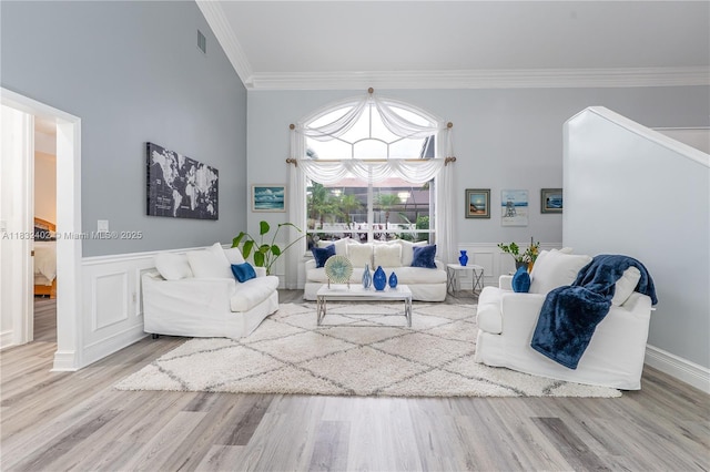 13850 NW 23rd St, Pembroke Pines, FL 33028 - living area with crown molding, wood finished floors, wainscoting, and a decorative wall