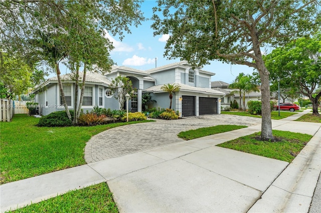 13850 NW 23rd St, Pembroke Pines, FL 33028 - view of front of house featuring driveway, a garage, and stucco siding