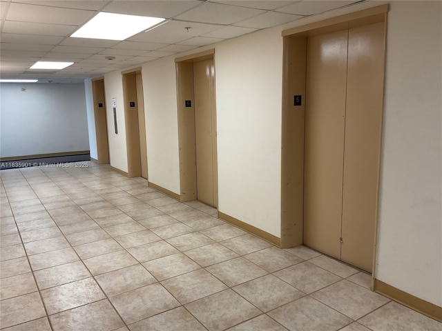 400 Kings Point Dr Unit 623, Sunny Isles Beach, FL 33160 - empty room with elevator, a paneled ceiling, and light tile patterned floors